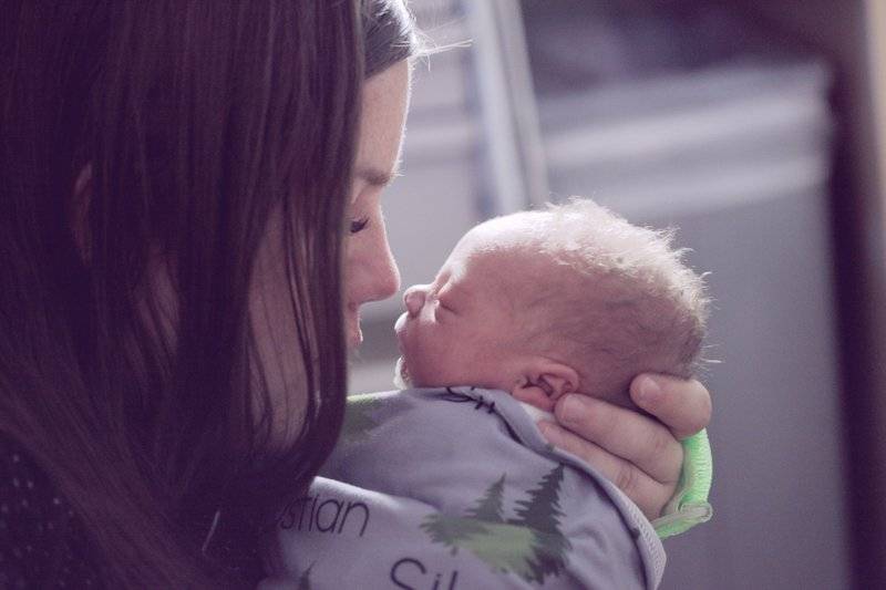 Mother with newborn child. The baby was born prematurely at 34 weeks gestation weighing in at over 6 pounds! He is in the neonatal intensive care unit, but expected to go home very soon.