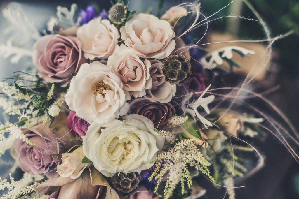 A bouquet of purple and white flowers on a table.