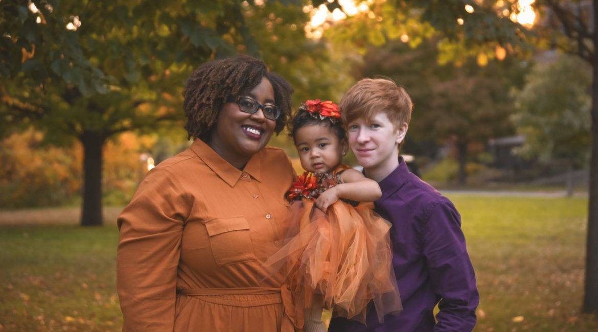 A family poses for an autumn photo in a park in Saint Paul.