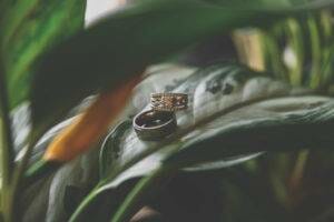 A wedding ring sitting on top of a plant.