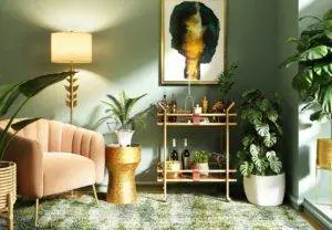 A living room with plants and a gold chair.