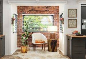 A kitchen with a brick wall and a cowhide chair.