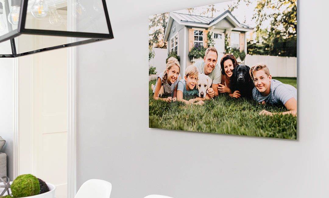 A family photo hanging on a wall in a dining room.