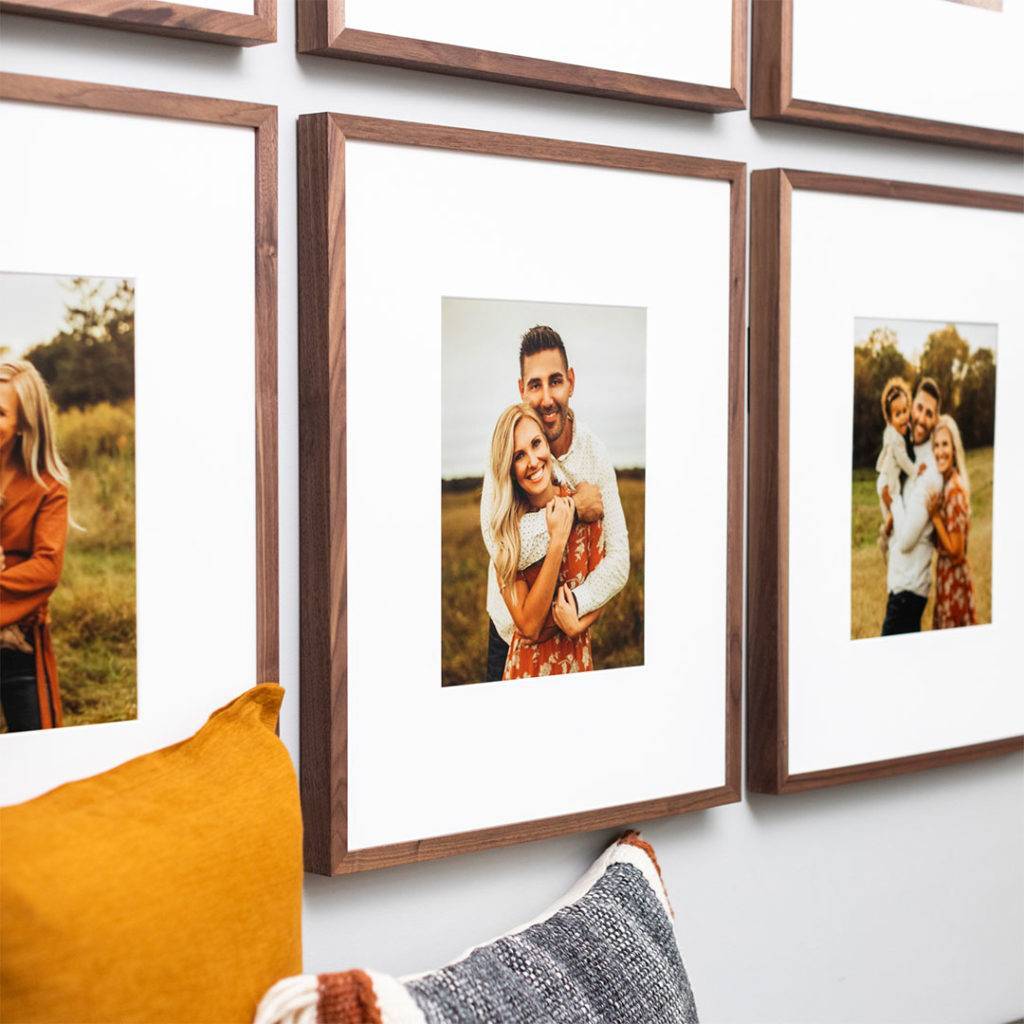 Four framed photos hanging on a wall.