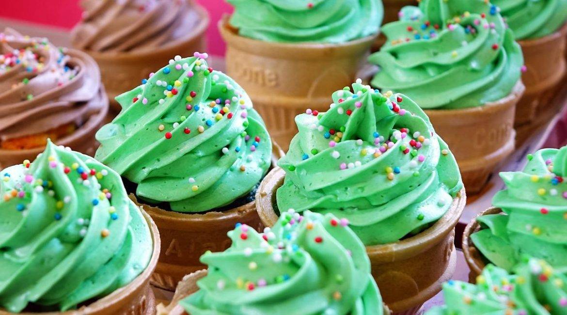 Ice cream cones with green frosting and sprinkles.