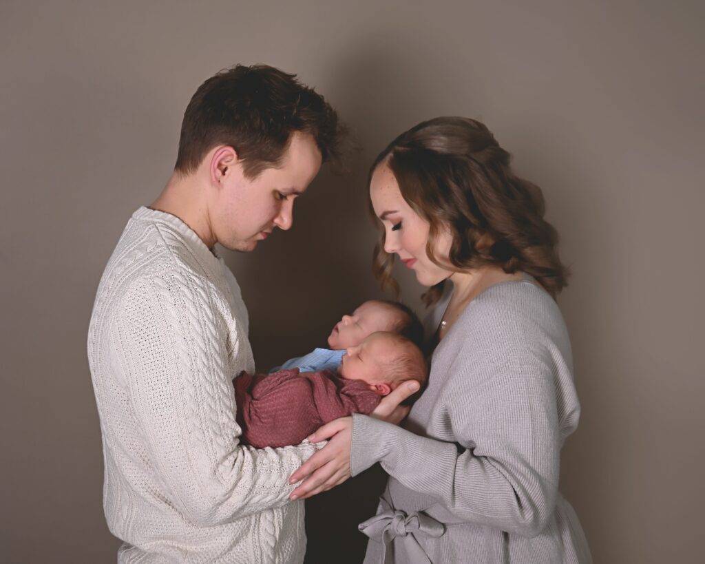 A man and woman holding a baby.