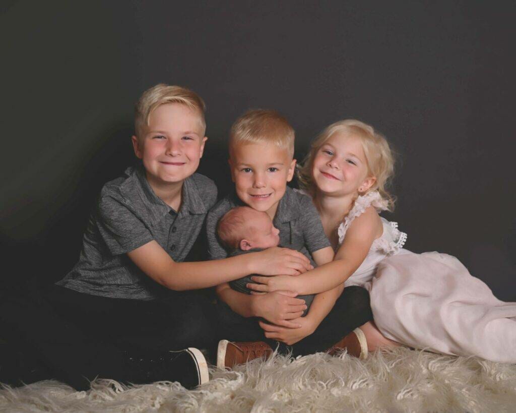 siblings with newborn during a newborn photography session