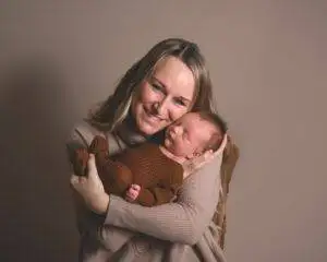 mom holding newborn baby, photography session