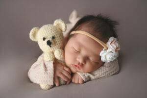 newborn holding a teddy bear, photography