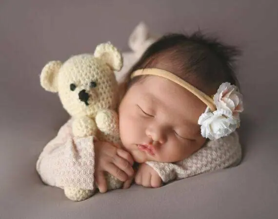 newborn holding a teddy bear, photography