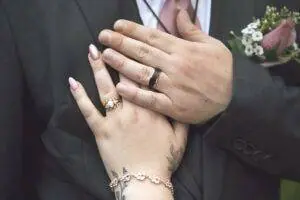 A man and a woman wearing wedding rings.