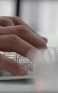 A close up of a person typing on a keyboard.