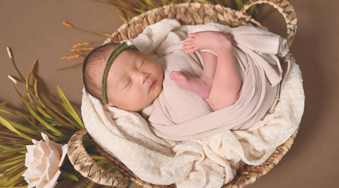 newborn baby girl in a basket, photography
