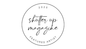 2025 Shutter Up Magazine Featured Artist" logo with handwritten style text inside a circular border on a black background.