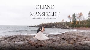 A bride and groom embrace on rocky shore by the water, under overcast sky, with "Giliane Mansfeldt Wedding Photography" text above them.