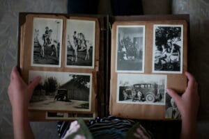 Family looking through old photo albums together — how to digitize old family photos