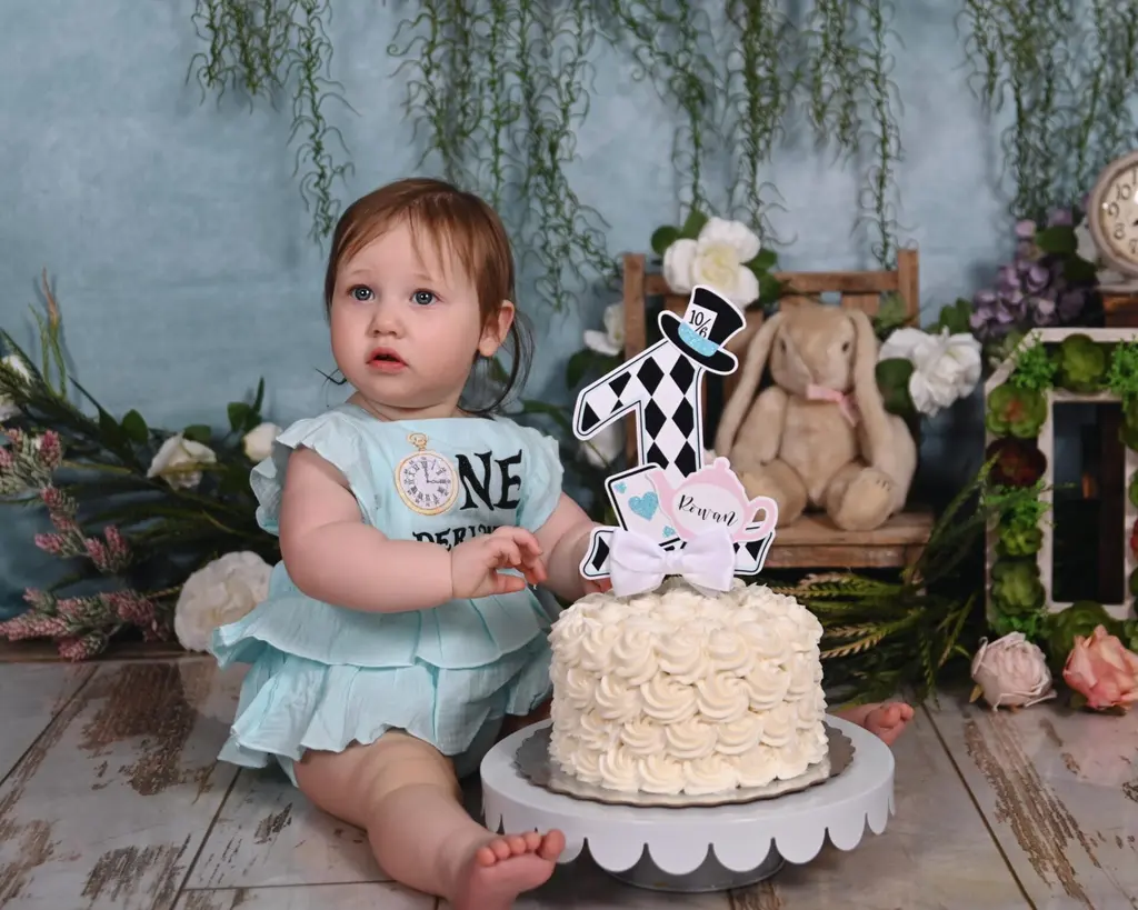 Baby's first birthday with a clean minimalist white rosette cake smash