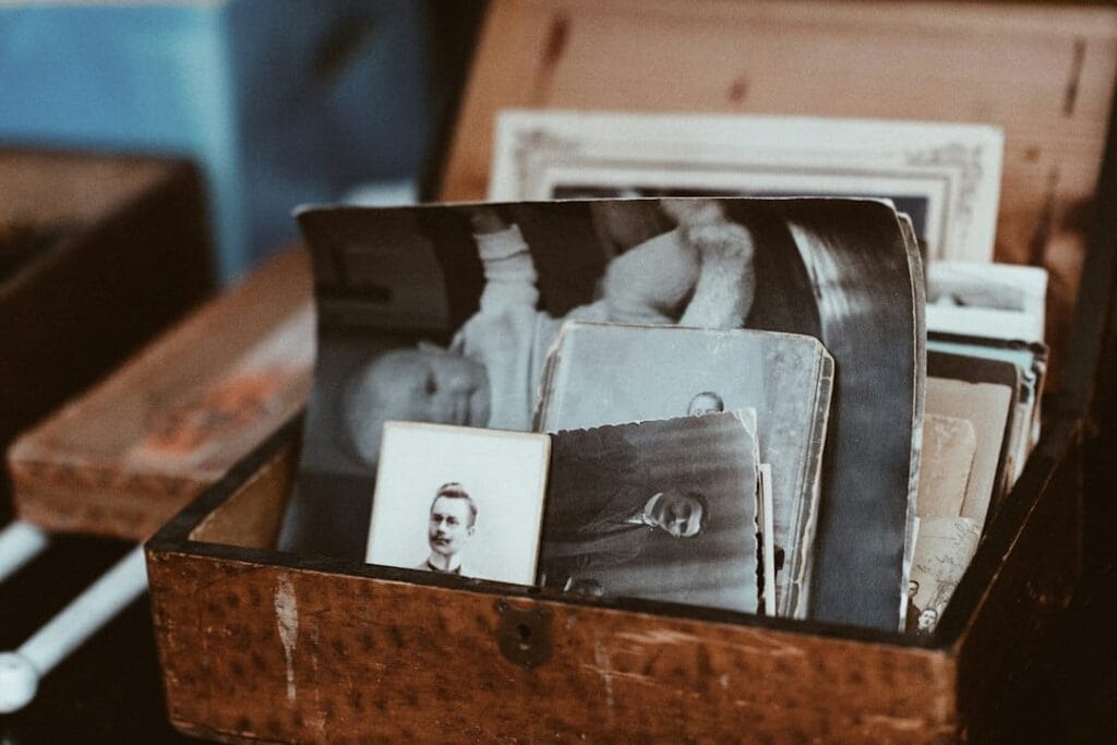 Old family photographs stored in a brown wooden chest