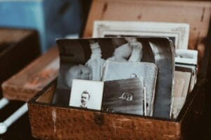 Old family photographs stored in a brown wooden chest