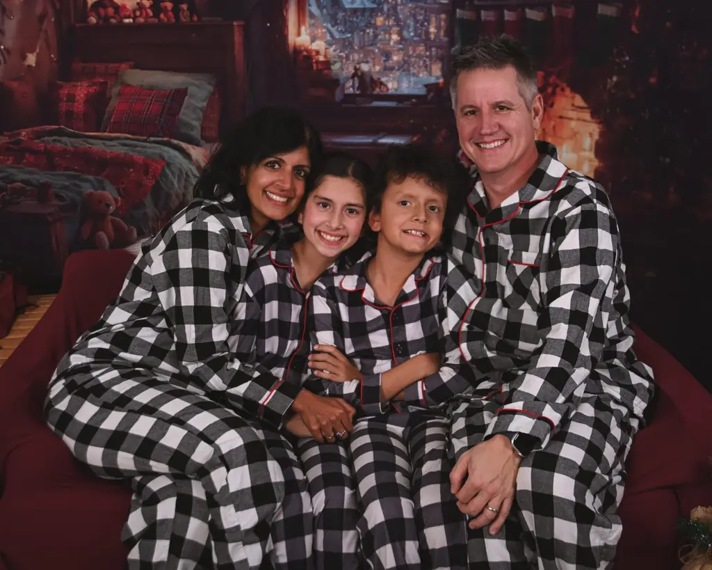 Family in matching plaid pajamas for a holiday card studio session