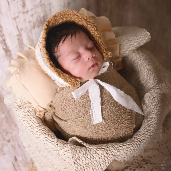 newborn with bonnet on posed in bucket, photography