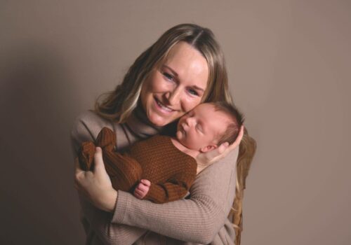 mom holding newborn baby, photography session