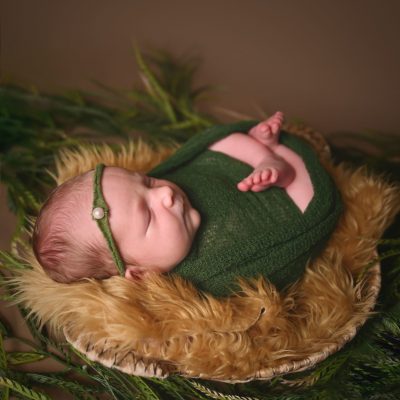 A_034 DONE a newborn posed in a studio basket