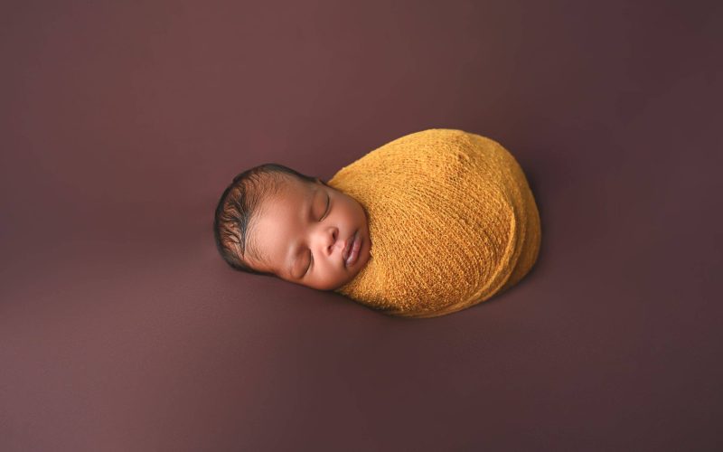 F_032 newborn in a wrap posed at Giliane E Mansfeldt Photography Studios