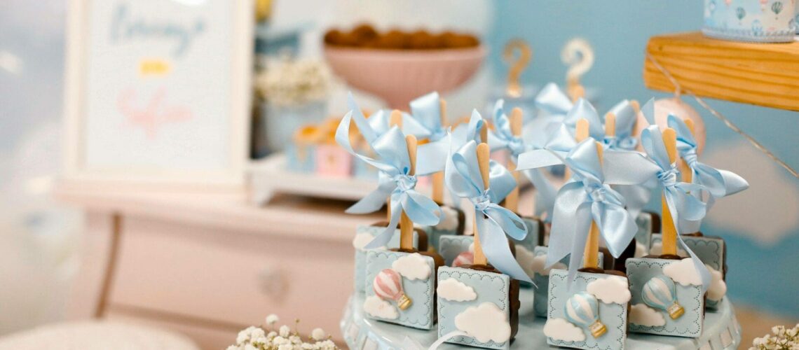 A baby shower with blue and white decorations and balloons.