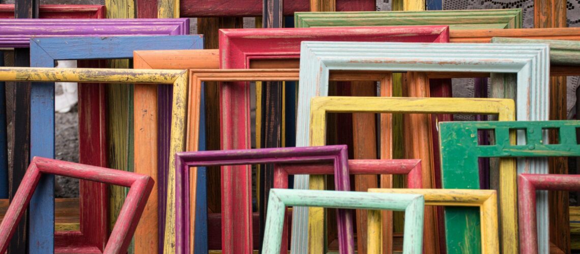A group of colorful wooden frames stacked on top of each other.